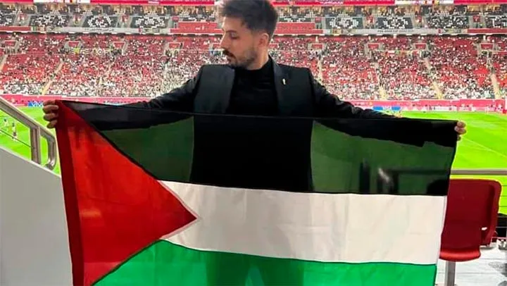 A man showing a Palestine flag in a World Cup stadium